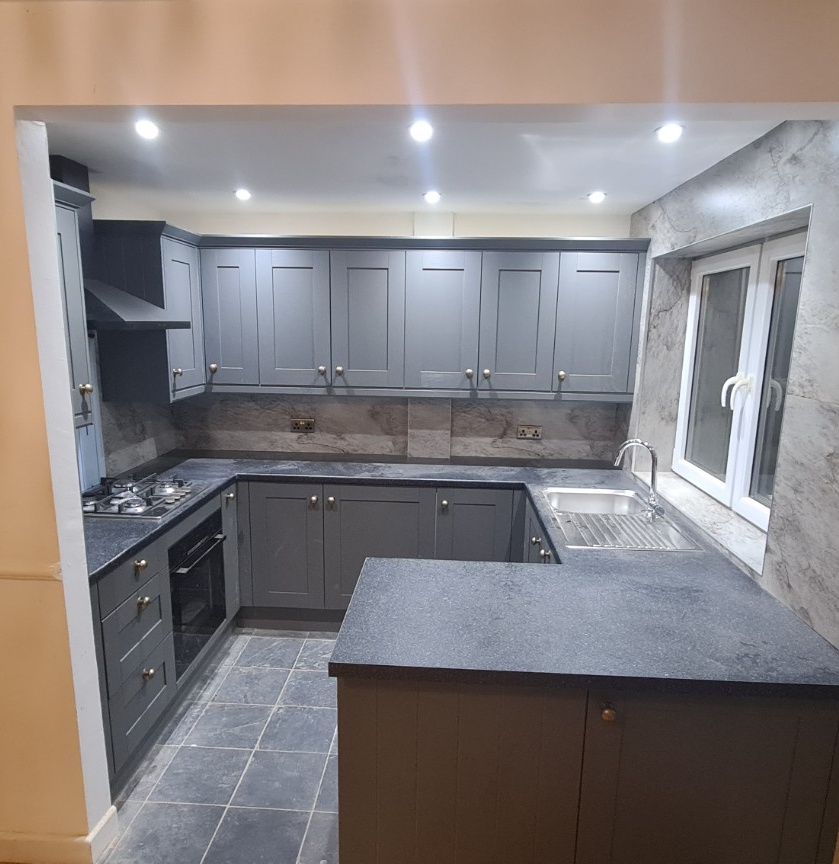 Completed grey Shaker kitchen with dark worktops and peninsula