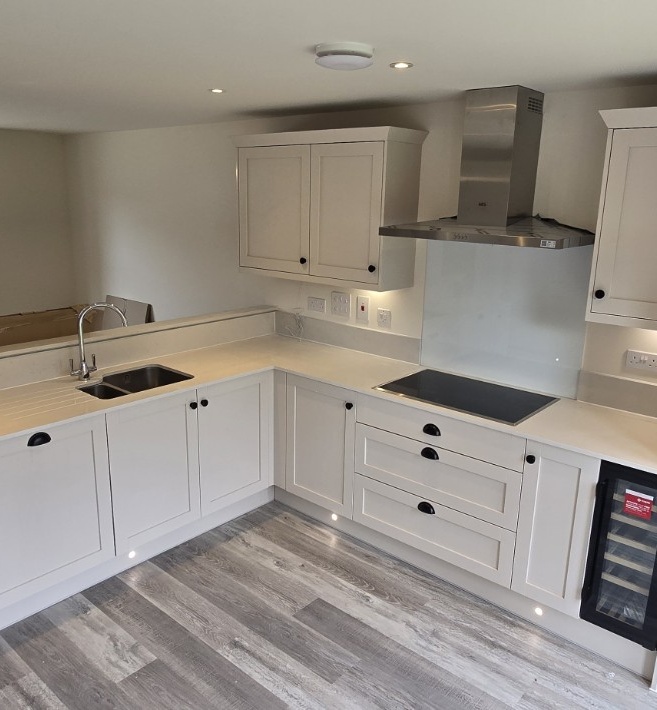 Detailed view of fitted light Shaker cabinetry and worktops